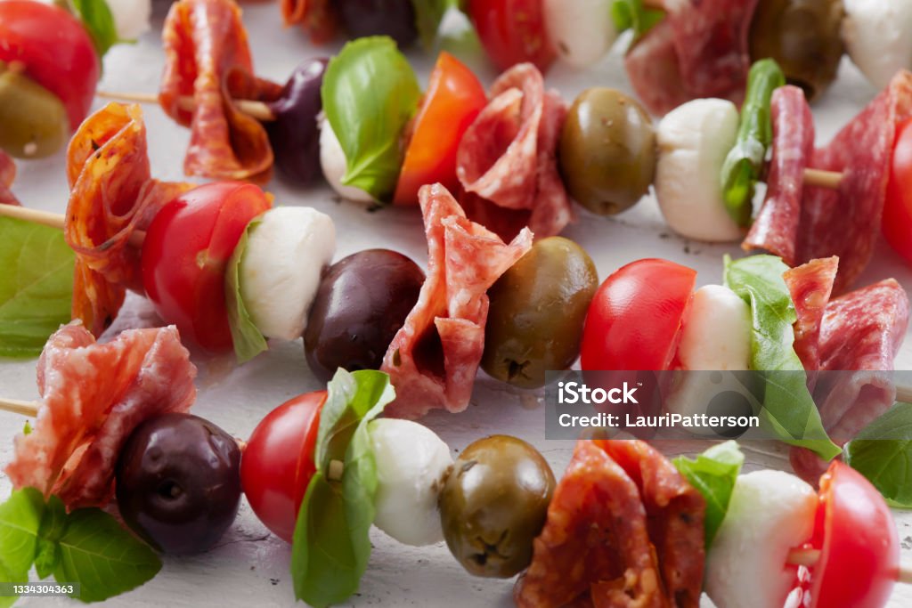 Antipasto Skewers Antipasto Skewers with Mozzarella, Cherry Tomatoes, Basil, Olives and Salami Antipasto Stock Photo