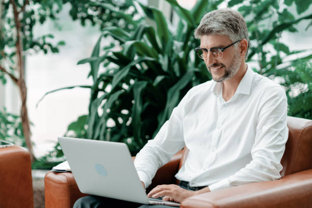 istock business man is working on a laptop in the office lobby 1334304582