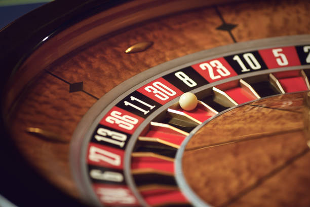 Close up roulette wheel white ball at zero in casino stock photo