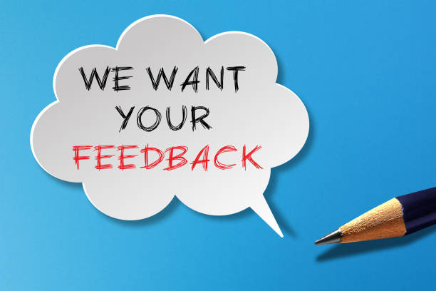 istock We Want Your Feedback written in speech bubble with pencil on blue background 1334308743