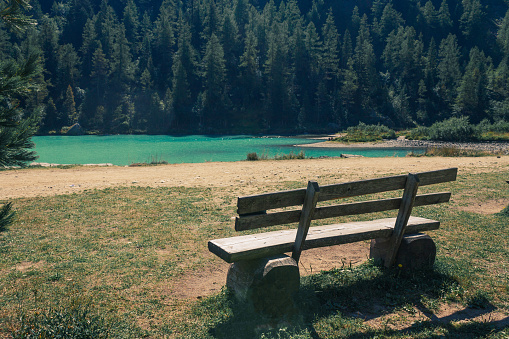 A park bench against Lake of fairies (Lago delle Fate in Italian) in Macugnaga, Italy.