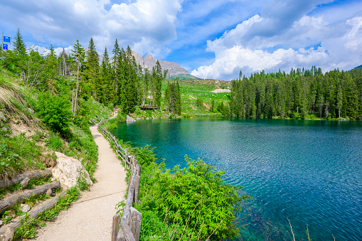 Paradise scenery at Karersee (Lago di Carezza, Carezza lake) in Dolomites of Italy at Mount Latemar, Bolzano province, South tyrol. Blue and crystal water. Travel destination of Europe.