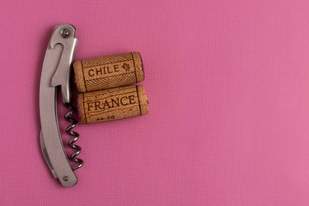 Names of wine countries France and Chile are written on corks. Wine corks close up. Names of wine countries France and Chile are written on corks. On a pink background. uncork wine stock pictures, royalty-free photos & images