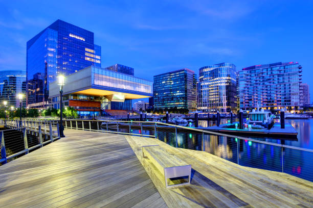 Boston Seaport District from the Harborwalk The Seaport District is a neighborhood in Boston, Massachusetts. It is part of the larger neighborhood of South Boston, and is also sometimes called the Innovation District. harborwalk stock pictures, royalty-free photos & images