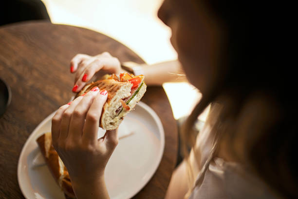 Young woman eating a sandwich