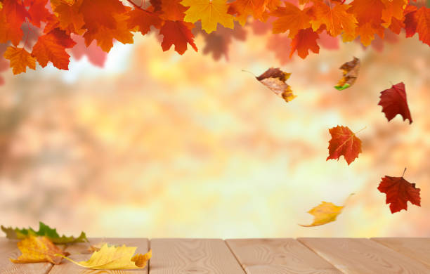 istock Autumn background with wooden tabletop and maple leaves 1334319412