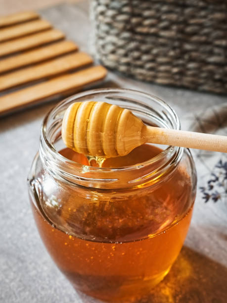 istock Honey on a honey dipper close-up 1334319637