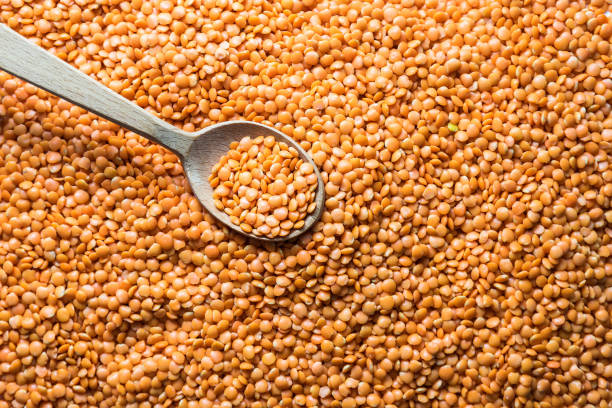 istock Red lentils in a wooden spoon, raw legumes 1334319664