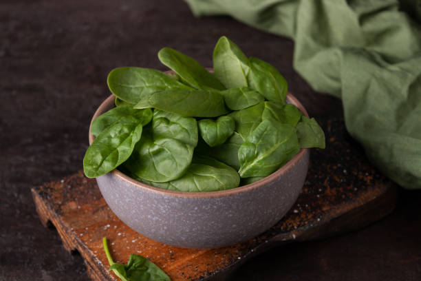 istock Spinach leaves in a clay cup dark photo 1334320434