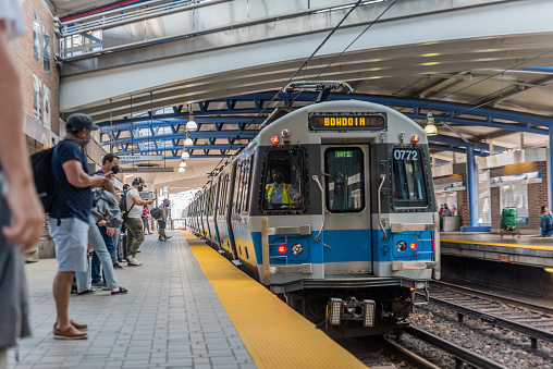 Boston Massachusetts, United States - August 8, 2021: View of passengers waiting for the train at the subway station, in Boston. The subway system has three heavy rail rapid transit lines and two light rail lines.
