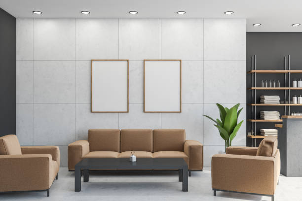 istock Two posters in the lobby with light brown sofa, armchairs 1334323054