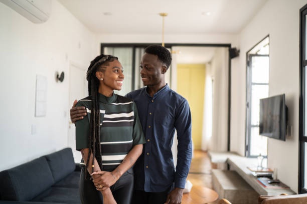 istock Happy couple looking at each other at home 1334323064