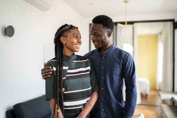 istock Happy couple looking at each other at home 1334323090