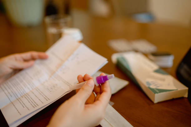 istock Woman unpacking rapid antigen test kit at home. 1334323152