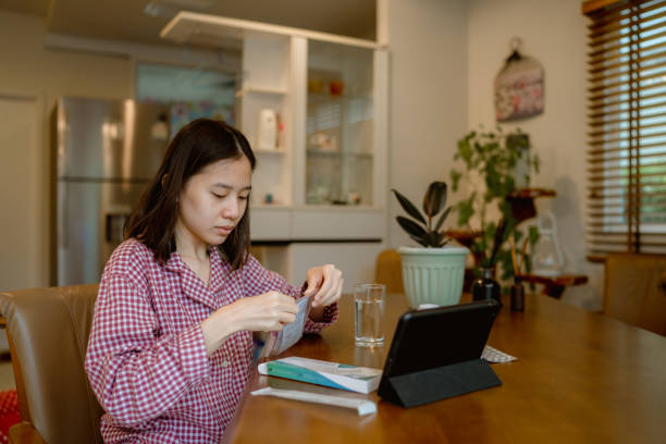 istock Woman unpacking rapid antigen test kit at home. 1334323177