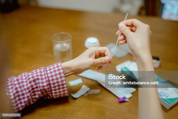 Young Woman Drops Swab In A Protective Plastic Tube Stock Photo - Download Image Now