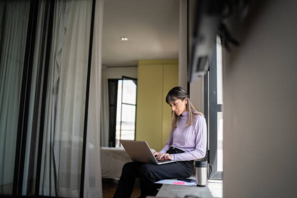 istock Young woman using laptop at home 1334323296