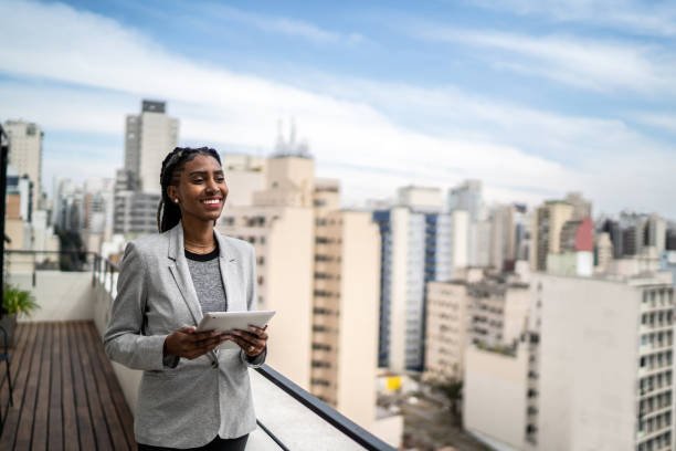 istock Young businesswoman contemplating and using digital tablet in a rooftop 1334323388