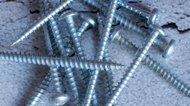 istock Metal screws on concrete background 1334323919