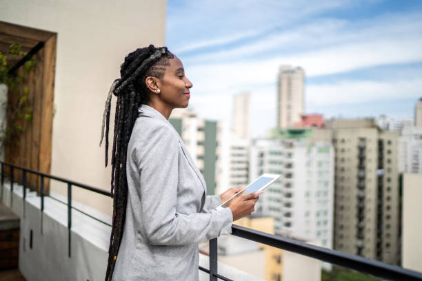 istock Young businesswoman contemplating and using digital tablet in a rooftop 1334323930