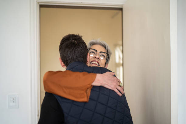 istock Senior woman greeting son at home 1334323985