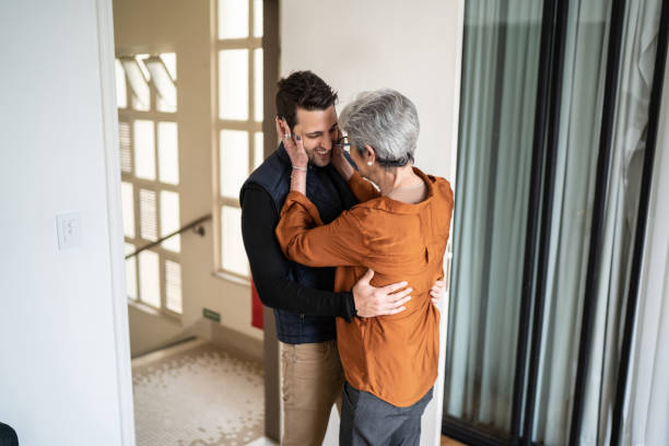 istock Senior woman greeting son at home 1334324012