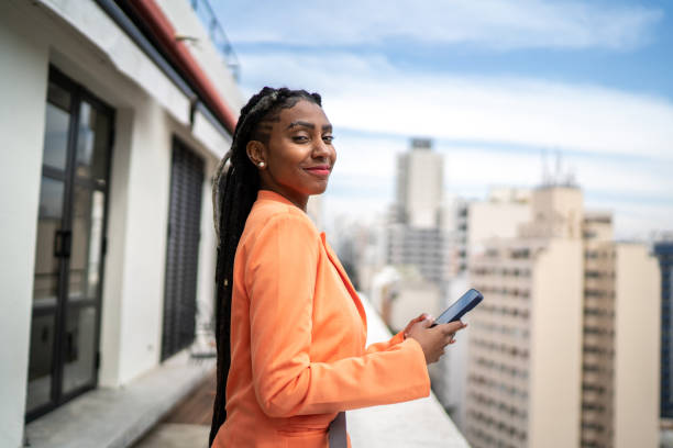 istock Portrait of a young woman using smartphone in a rooftop 1334324043