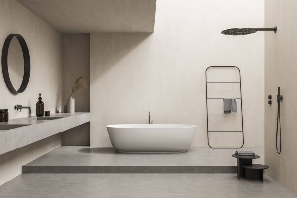 istock Beige bathroom with tub and accent round mirror 1334324090