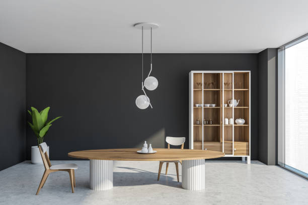 istock Dining room space with dark walls and cupboard 1334324202
