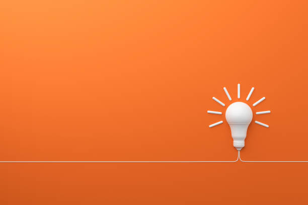 concepto idea innovación bombilla sobre fondo naranja. - compact fluorescent lightbulb fotografías e imágenes de stock