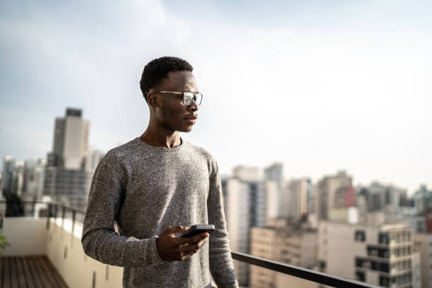 istock Young man contemplating from building terrace 1334324599