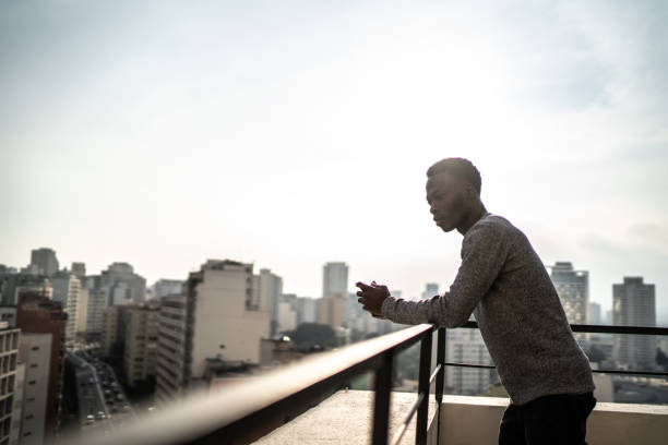 istock Young man contemplating from building terrace 1334324610