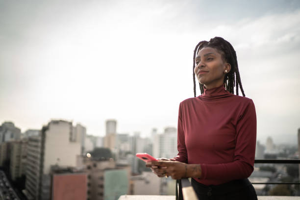 istock Young woman looking away contemplating in a rooftop 1334325221