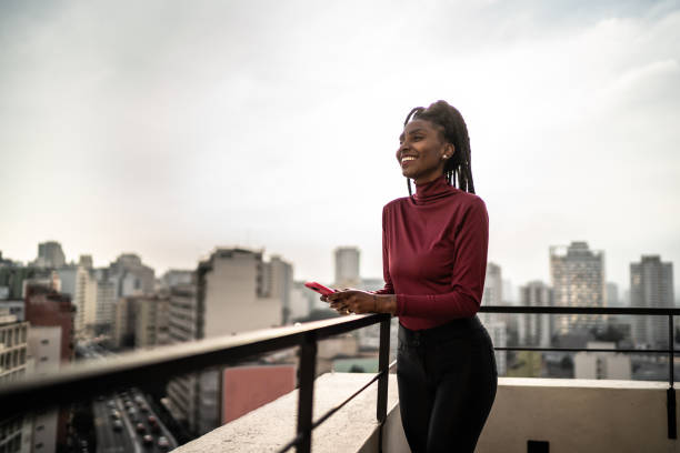 istock Young woman looking away contemplating in a rooftop 1334325309