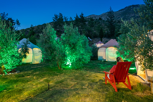 Women relaxing in the glamping area at the night