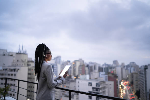 istock Businesswoman contemplating and using digital tablet in a rooftop 1334325598