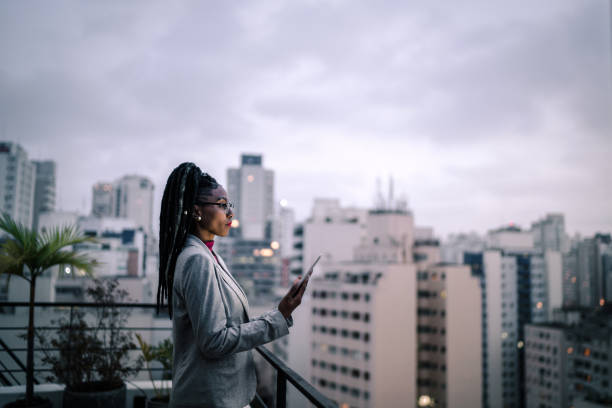 istock Businesswoman contemplating and using digital tablet in a rooftop 1334325653