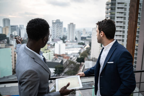 istock Business partners looking away contemplating in a rooftop 1334325680