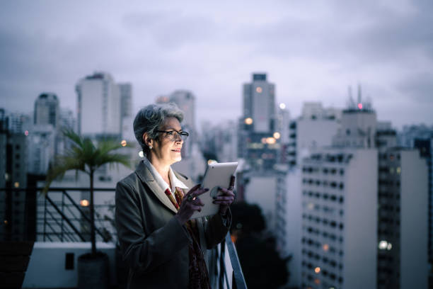 istock Senior businesswoman contemplating and using digital tablet in a rooftop 1334326831