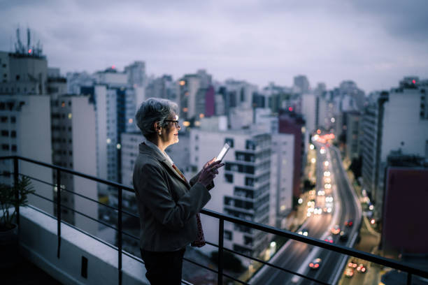 istock Senior businesswoman contemplating and using digital tablet in a rooftop 1334326834