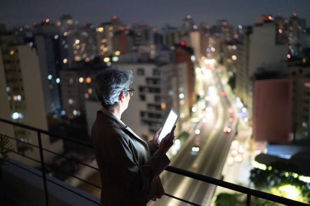 istock Senior businesswoman contemplating and using digital tablet in a rooftop 1334326844