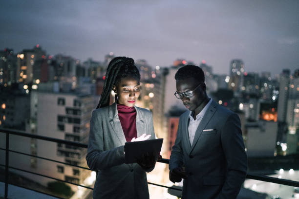 istock Business partners using digital tablet and talking in a rooftop 1334326862