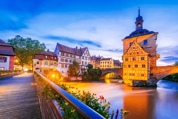 Bamberg, Bavaria. Old town hall, Obere Brucke and Regnitz river dusk illuminated. Germany city break travel place.