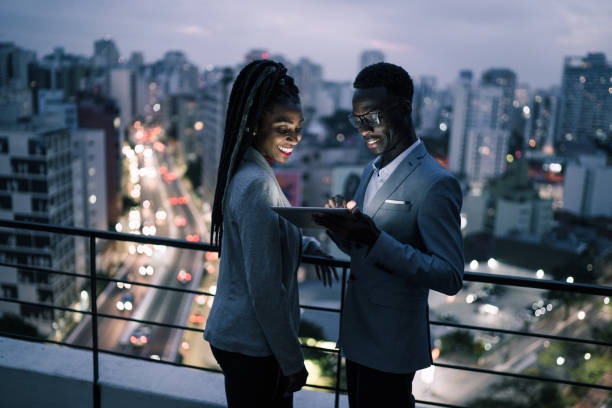 istock Business partners using digital tablet and talking in a rooftop 1334326940