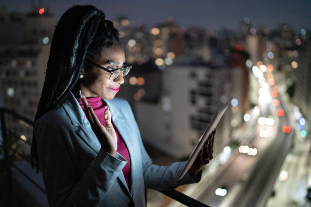 istock Businesswoman doing a video call on digital tablet in a rooftop 1334326965