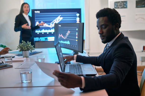istock Black businessman reading paper during meeting 1334328343