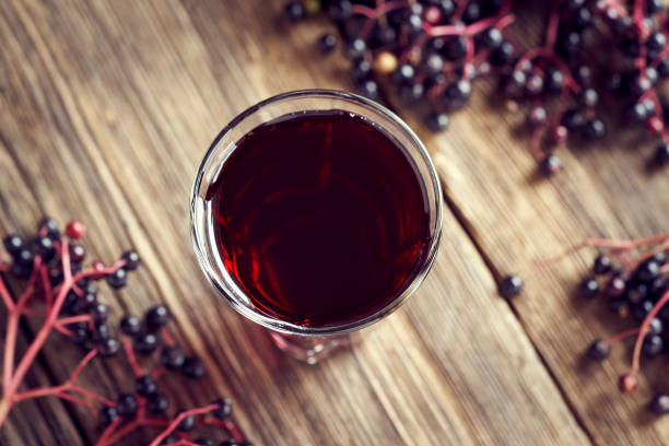 istock A glass of black elder syrup with fresh elderberries 1334330072