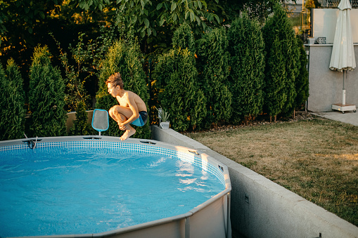 Kids playing in home swimming pool