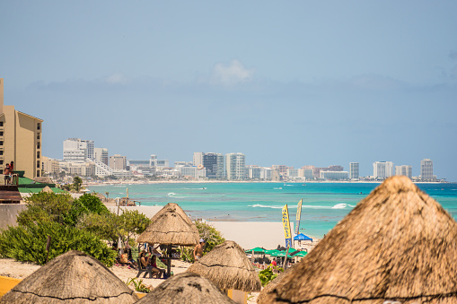 Cancun, Mexico - August 8, 2021: Cancun Hotel Zone - view from Playa Delfines. Hotel Zone in Cancun is the home to all-inclusive resorts, bars, clubs, and white sand beaches. In 2019, Cancun received 6.15 million foreign visitors.
