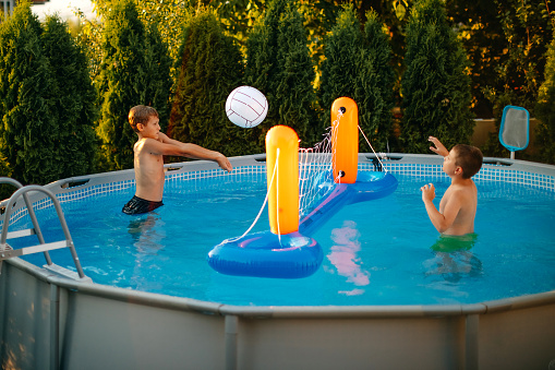 Kids playing in home swimming pool
